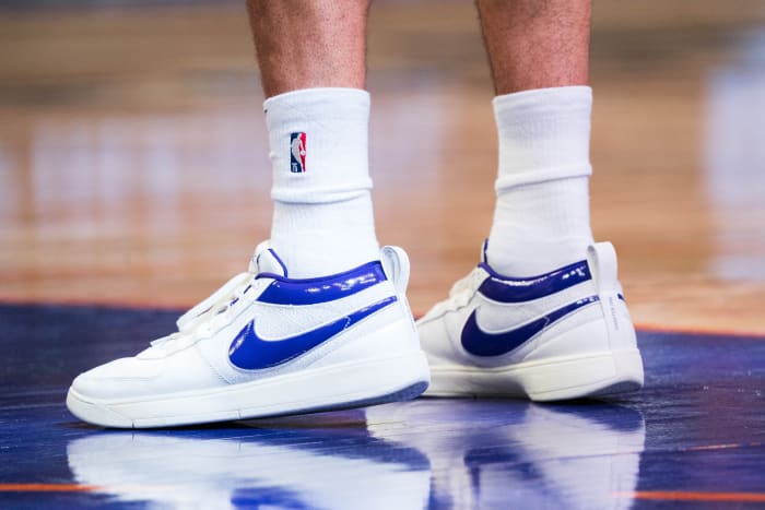 Phoenix Suns guard Devin Booker's white and purple Nike sneakers.